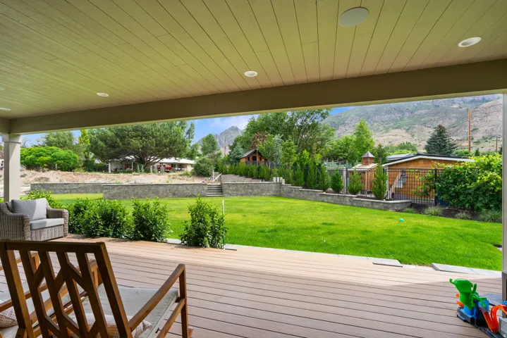 Covered outdoor patio with wood-finish decking and recessed lighting