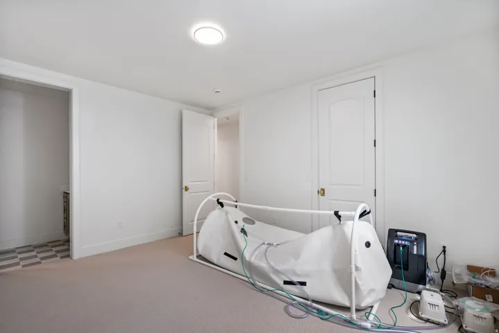 Room featuring neutral-toned carpet flooring, white walls, and a recessed ceiling light
