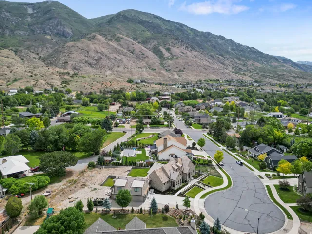 Aerial perspective showcasing a residential neighborhood with mountainous terrain in the background