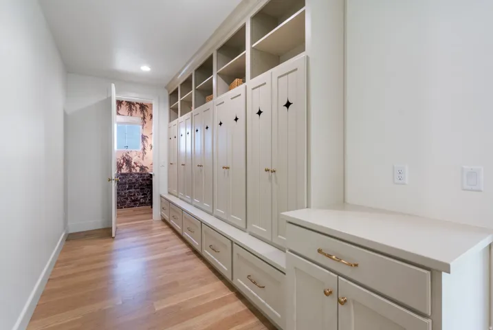 Expansive built-in cabinetry and bench seating featuring custom doors with star cutouts and brass hardware