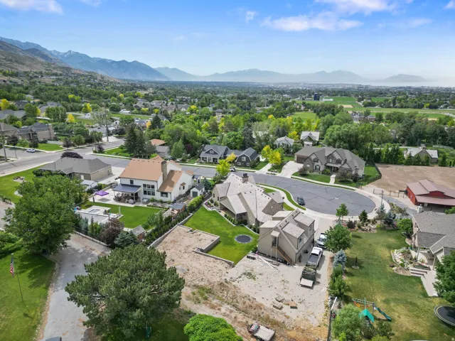 Aerial perspective showcasing residential properties with a mountainous backdrop