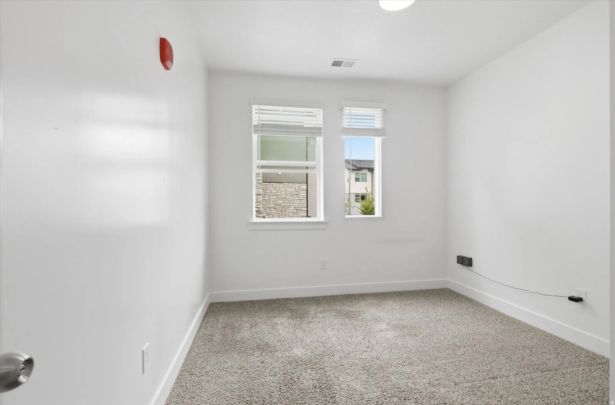 Neutral-toned carpeting paired with crisp white walls and baseboards