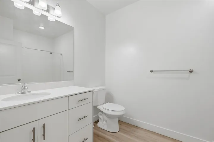 Bathroom featuring a white vanity with brushed nickel hardware, a white countertop, and an integrated sink