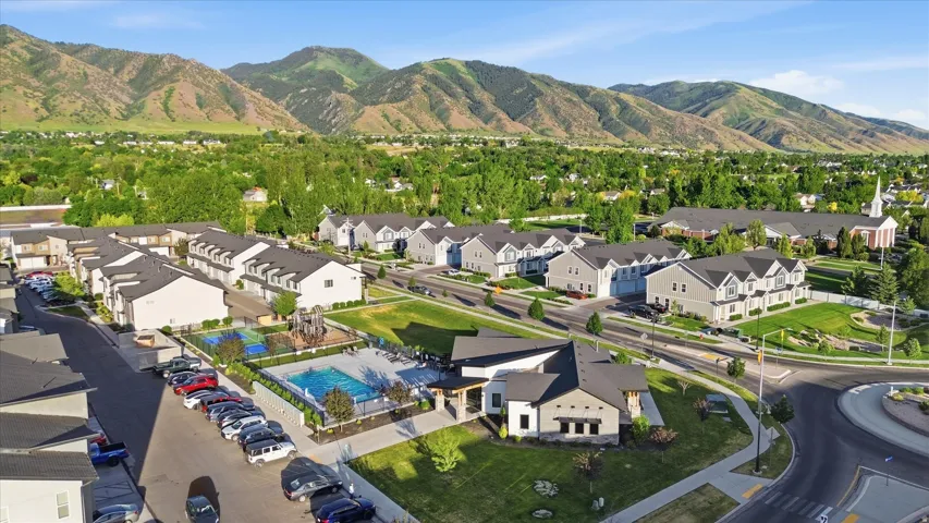 Aerial perspective showcasing a community with a swimming pool, recreational area, and structured townhome residences