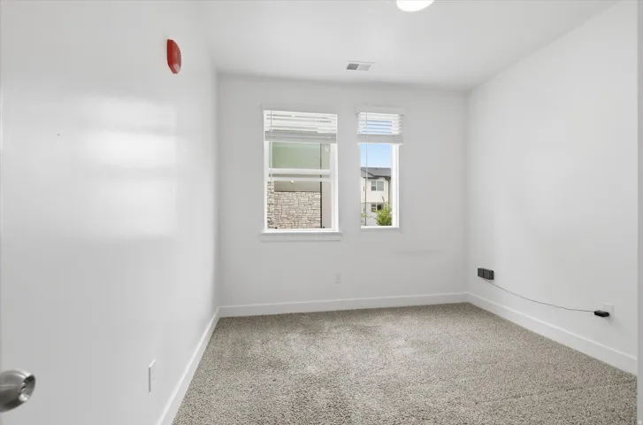 Neutral-toned carpeting paired with crisp white walls and baseboards