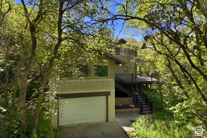 Multi-level exterior with ample surrounding foliage
