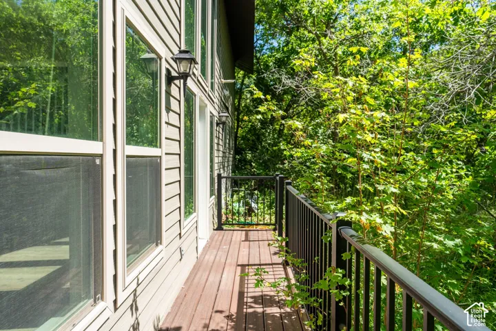 Private balcony with wood-finish decking and dark metal railings