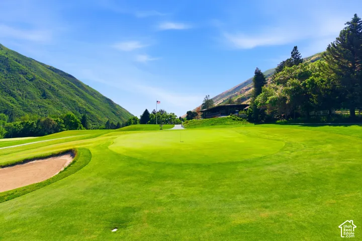 Expansive golf course green with a sand trap