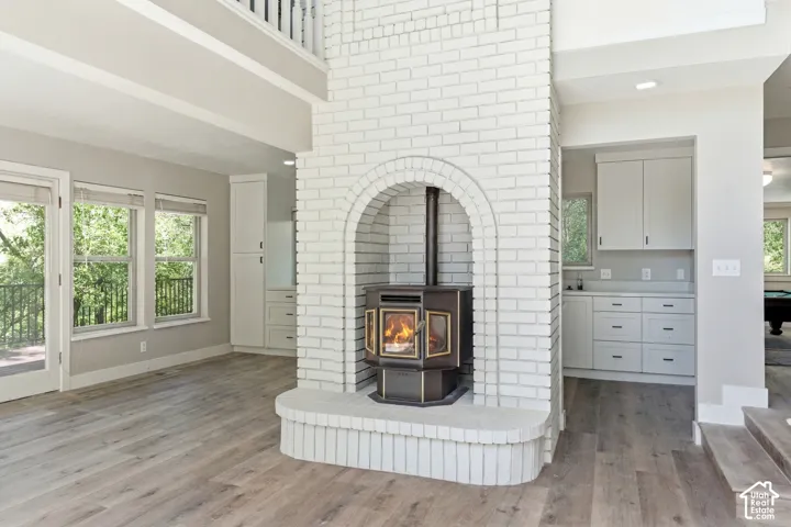 Prominent white brick fireplace with an arched opening and raised hearth