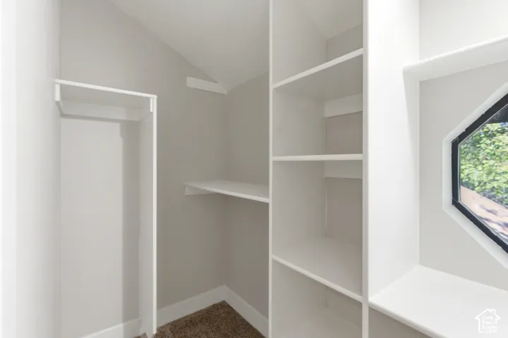 Custom closet system featuring built-in shelving and hanging rods