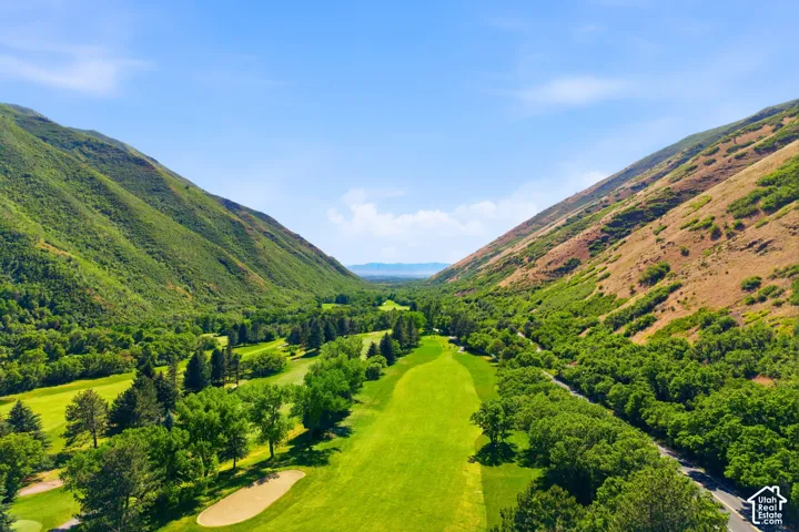 Expansive golf course setting featuring manicured fairways and mature trees