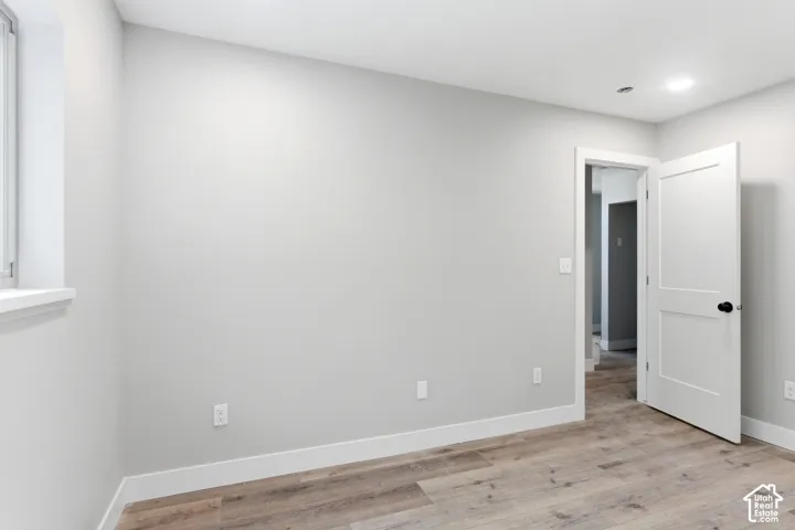 Neutral-toned walls complement the wood-finish flooring