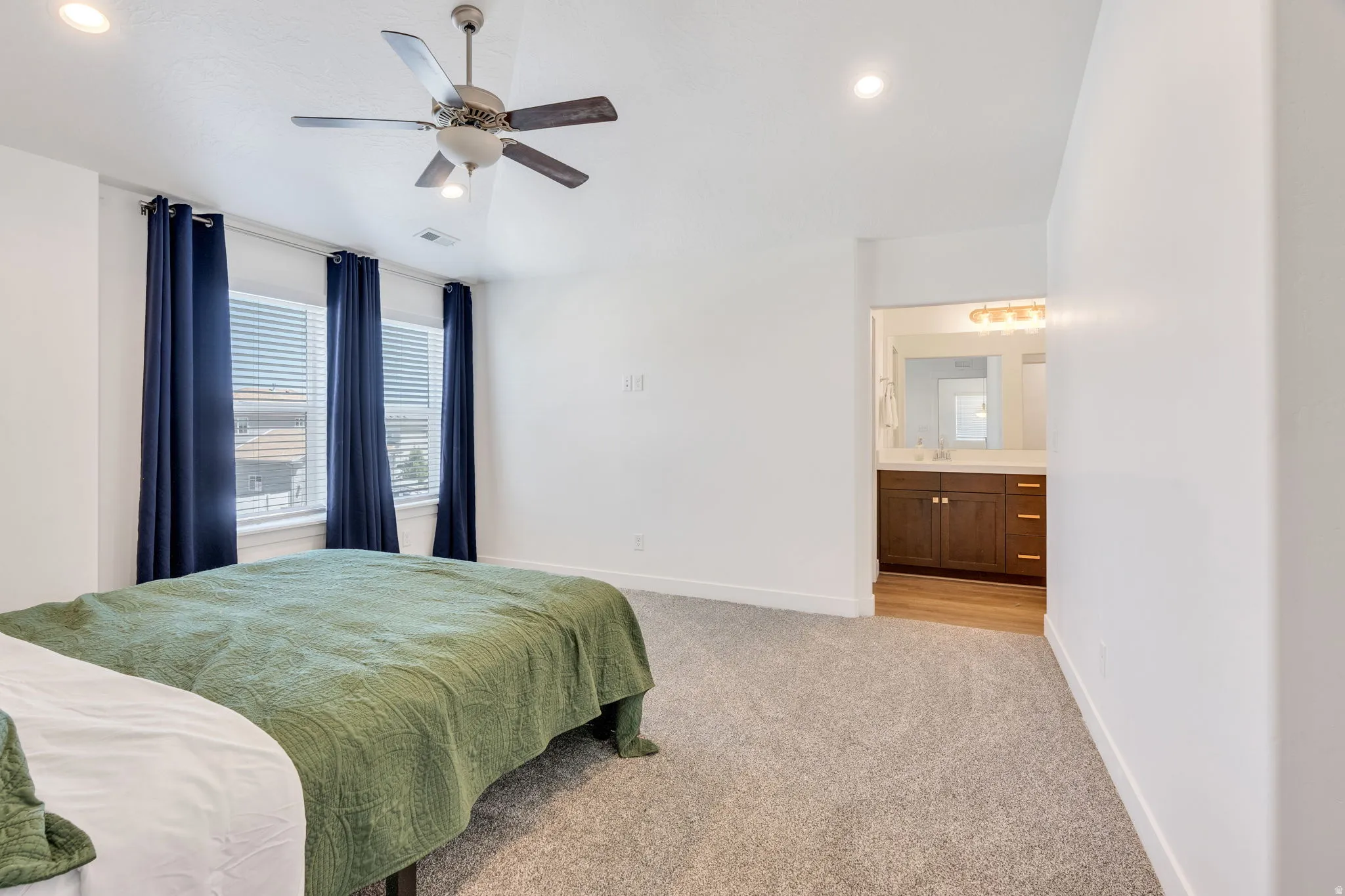 Carpeted room with recessed lighting and a ceiling fan