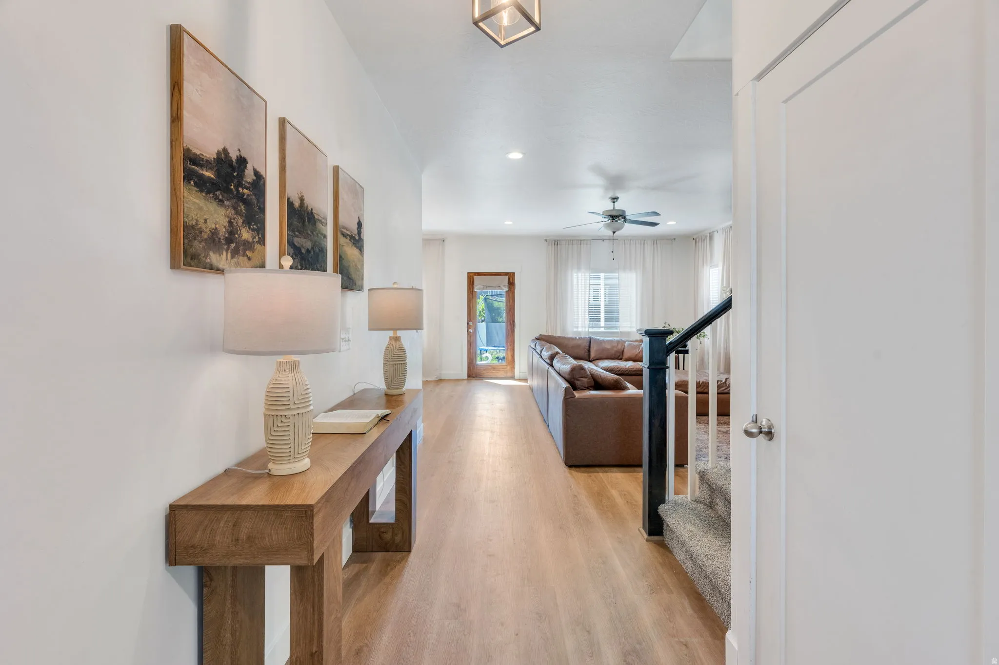 Bright entryway featuring wood-finish flooring extending into the main living area