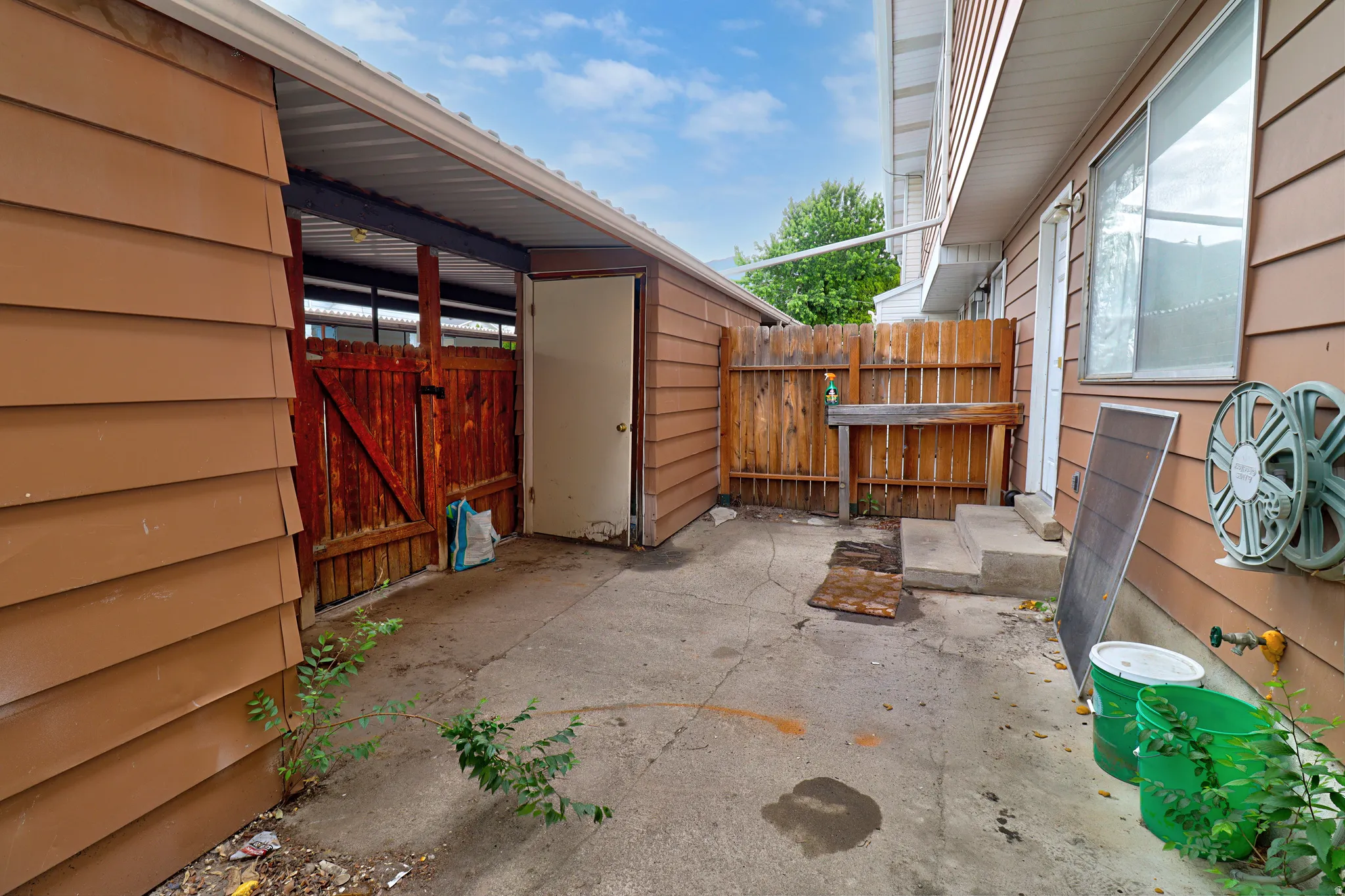 Patio Looking East, Storage Closet, Gate to Carport