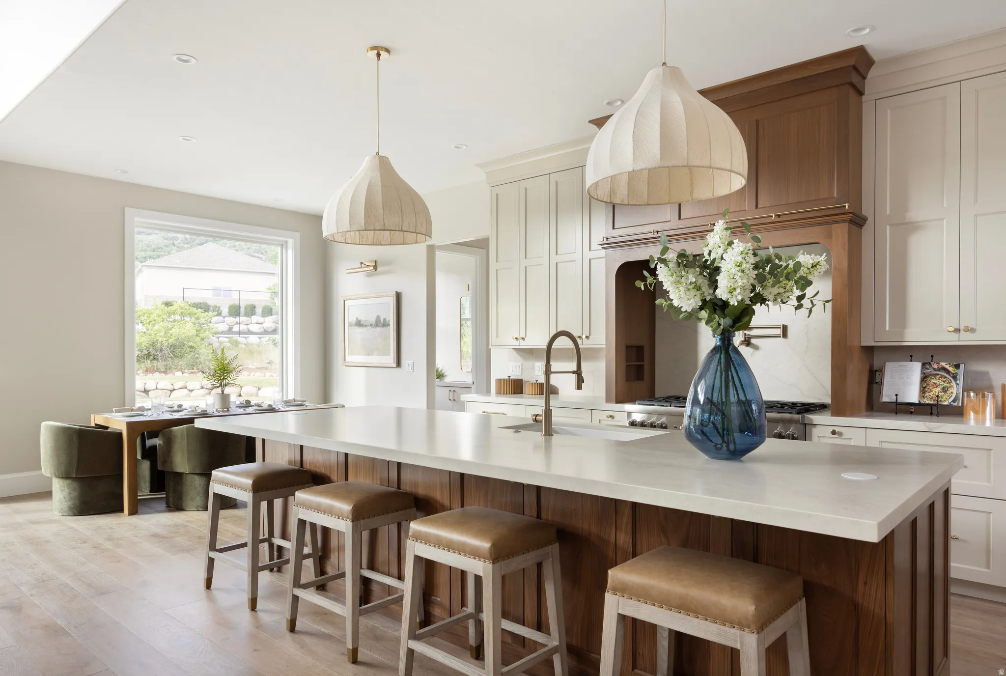 Expansive kitchen island with a light-toned countertop and wood-finish paneling