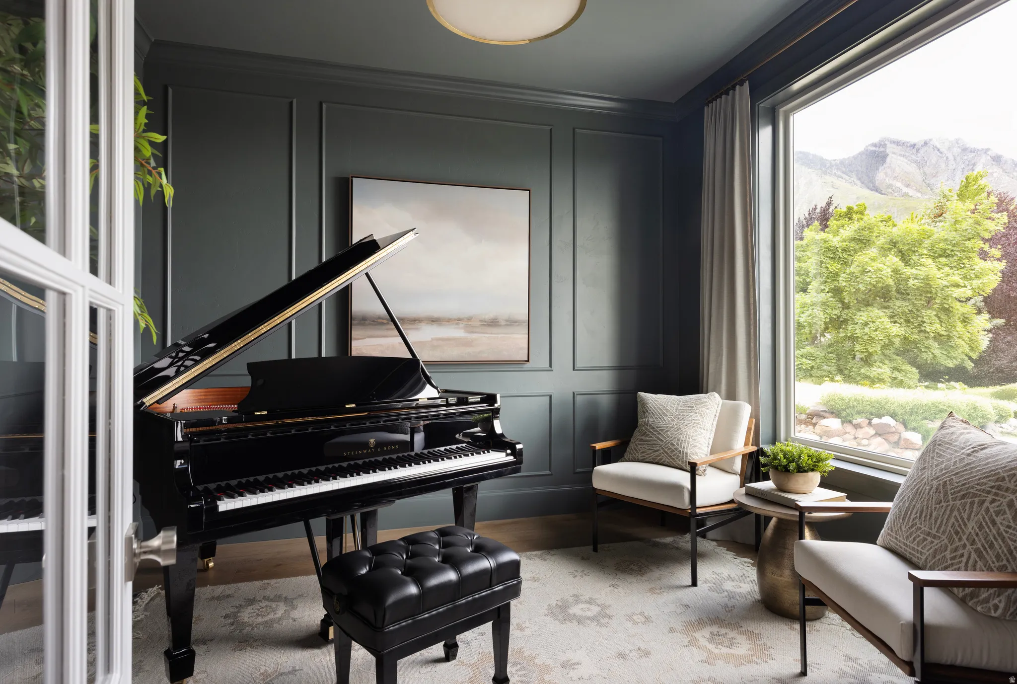 Formal living space featuring dark paneled walls, a large picture window, recessed lighting, and wood-finish flooring