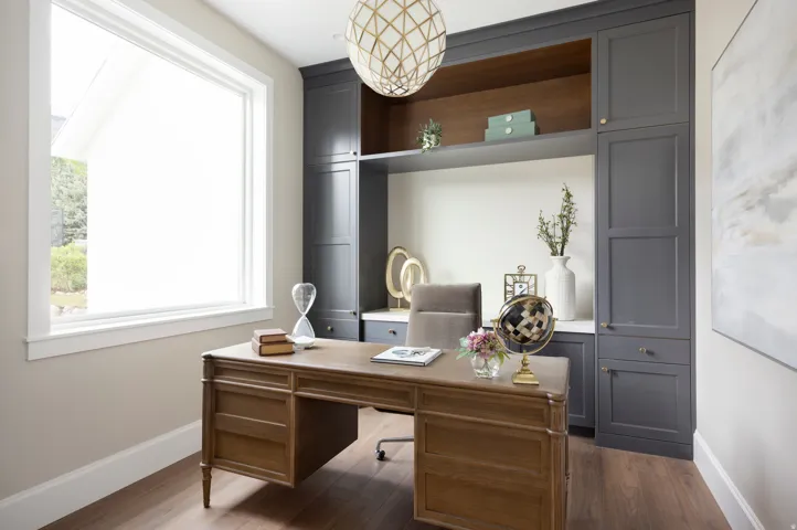 Dedicated room featuring wood-finish flooring, a large window, custom built-in cabinetry with open shelving, and a decorative ceiling light fixture