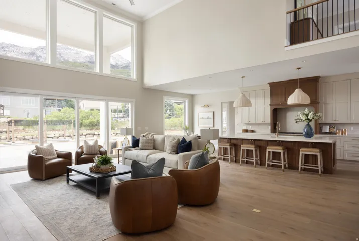 Expansive living area with high ceilings and wood-finish flooring
