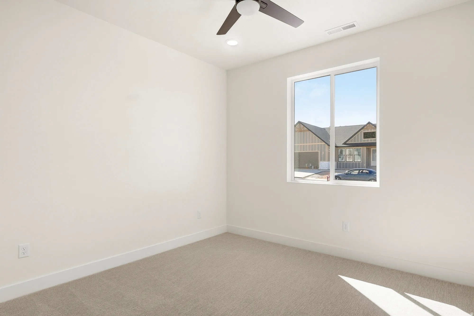 Recessed ceiling lighting, ceiling fan with dark finish blades, light-toned carpet flooring, white trim, and a large window