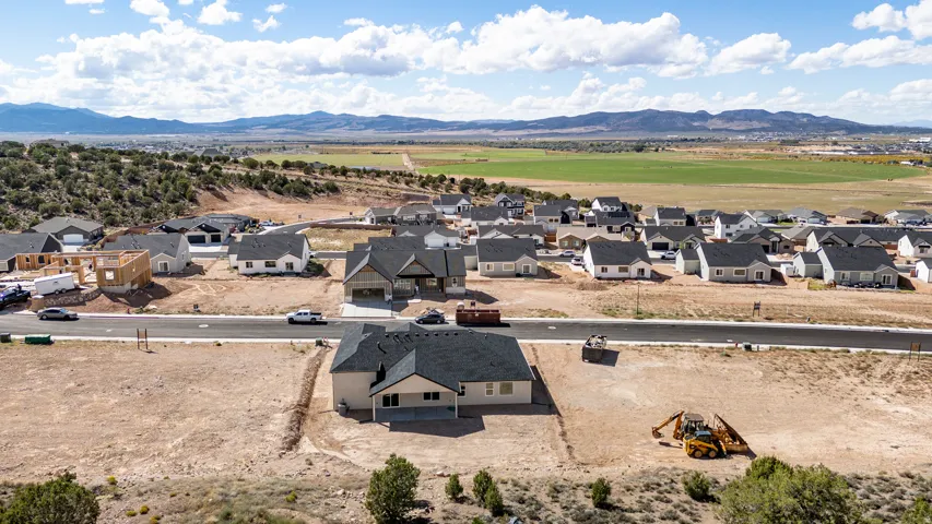 New construction residential development featuring a paved street and surrounding mountain ranges