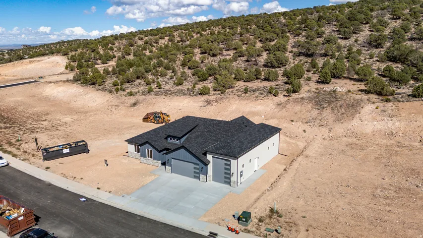 Contemporary exterior with a dark gray asphalt shingle roof, light gray siding, and stone accents
