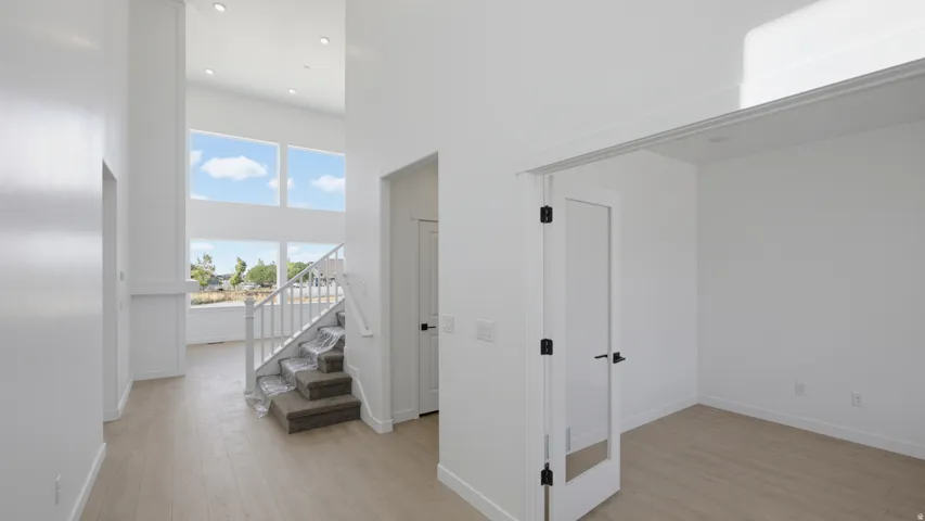 Two-story entry foyer with wood-finish flooring
