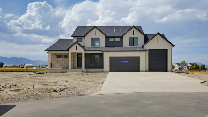 Contemporary two-story exterior with a two-tone facade, black-framed windows, and an attached two-car garage