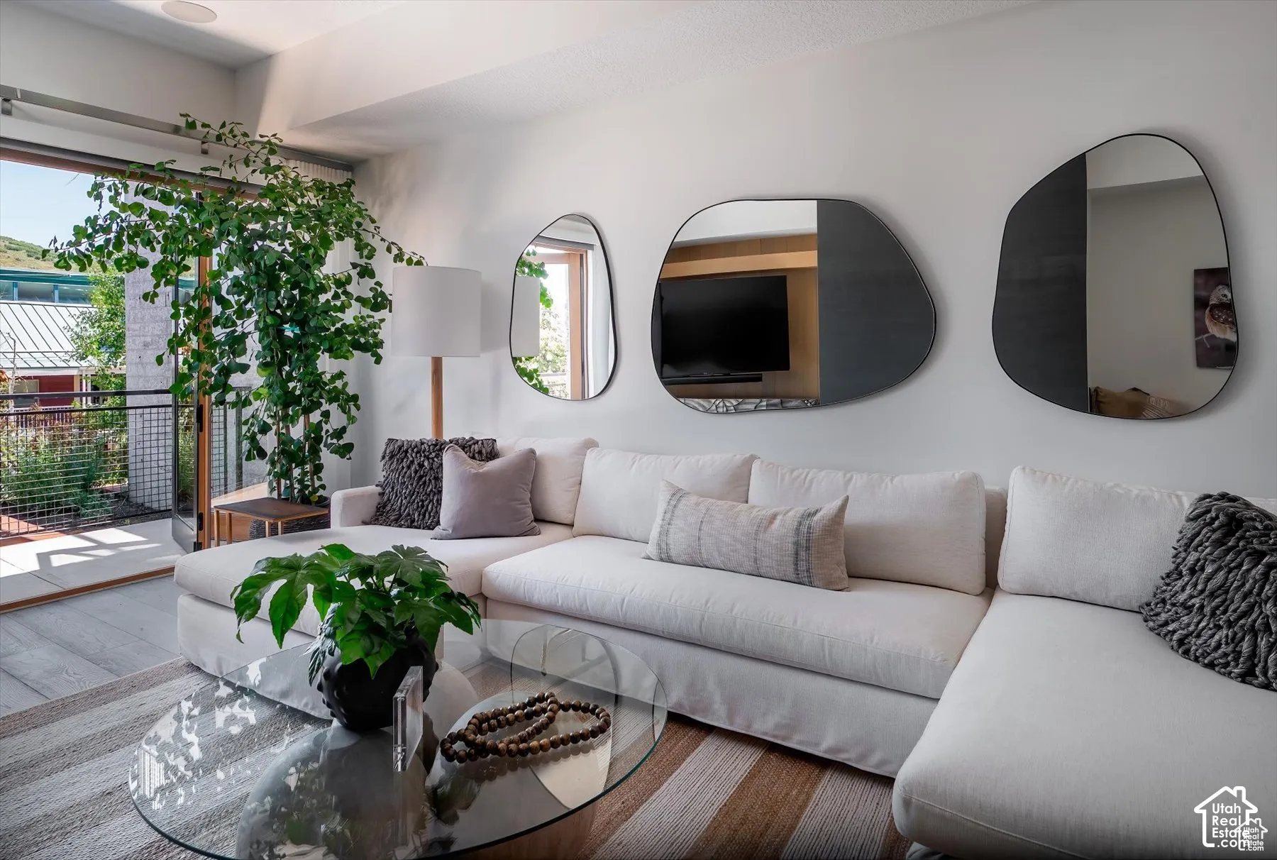 Living area featuring a spacious sectional sofa and wood-finish flooring