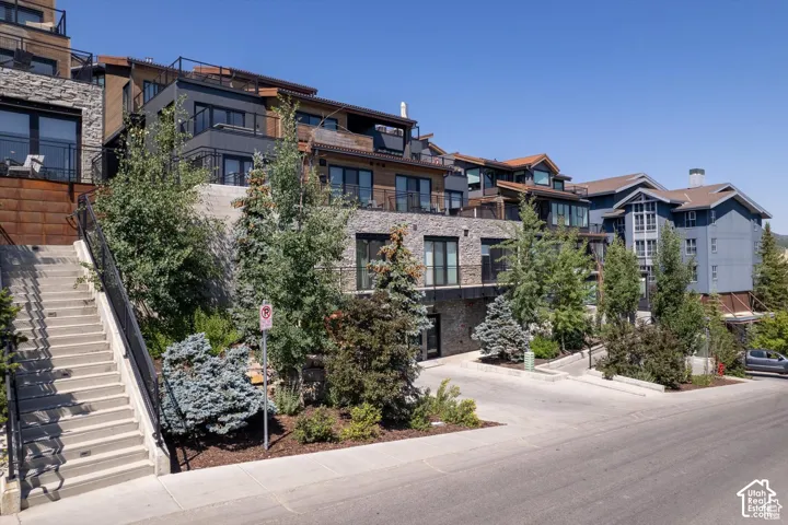 Multi-level residential structures featuring varied exterior finishes including stone, wood paneling, and siding