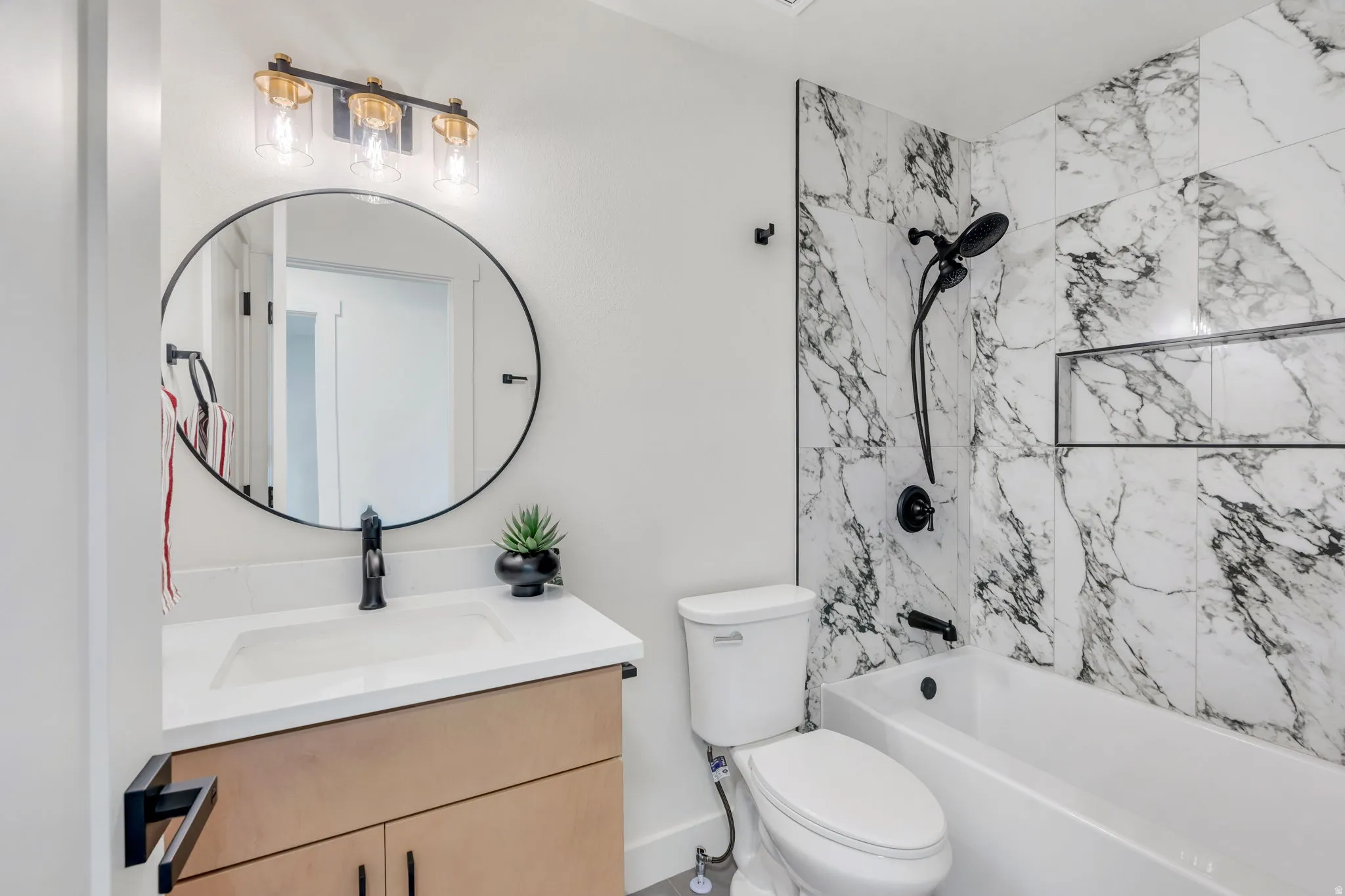 Full bathroom featuring a single vanity with wood-finish cabinetry and a white countertop