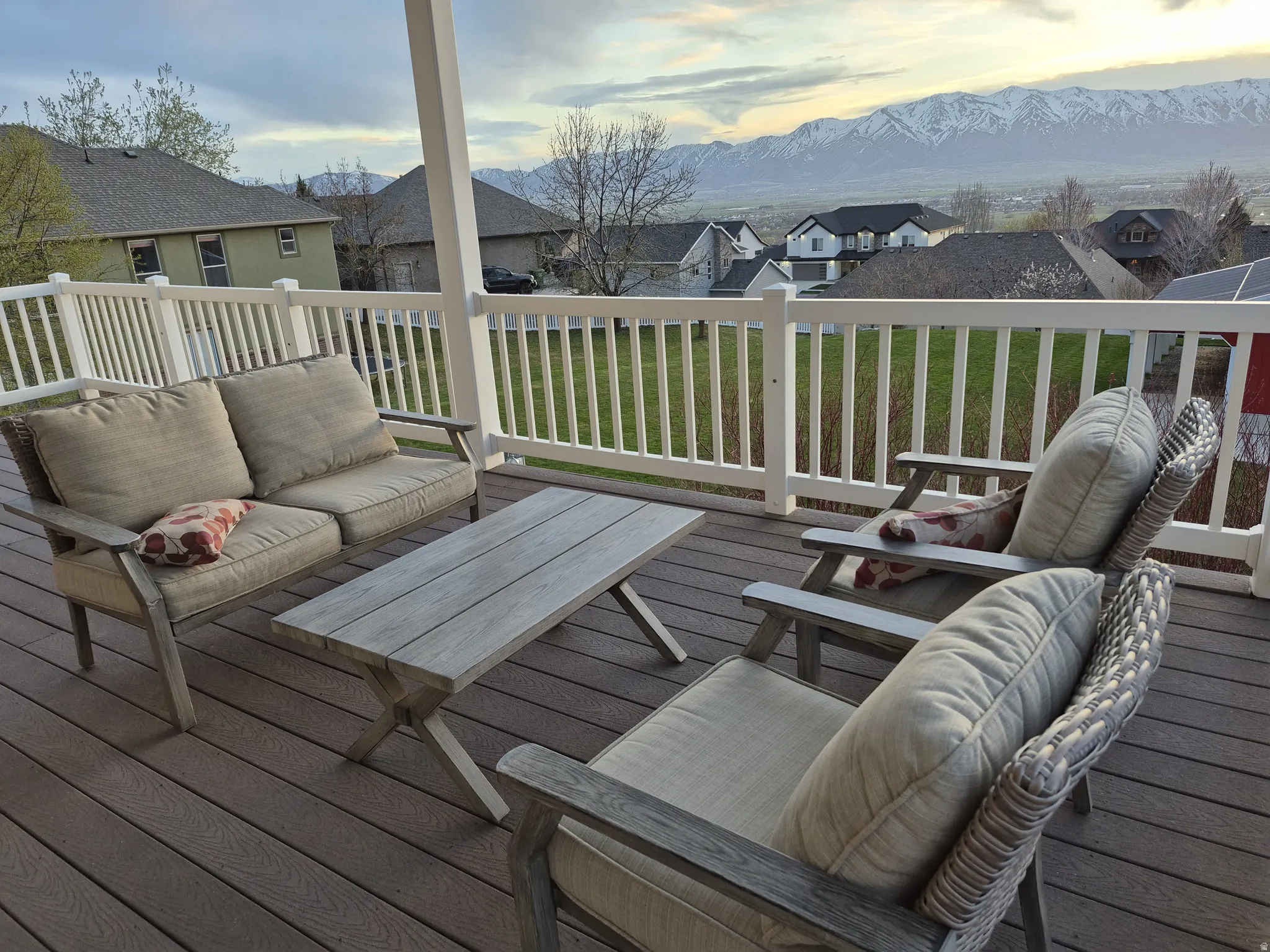 Expansive covered outdoor deck featuring composite wood-finish flooring and white railing. Great place to relax and enjoy the stunning sunsets and holiday fireworks.