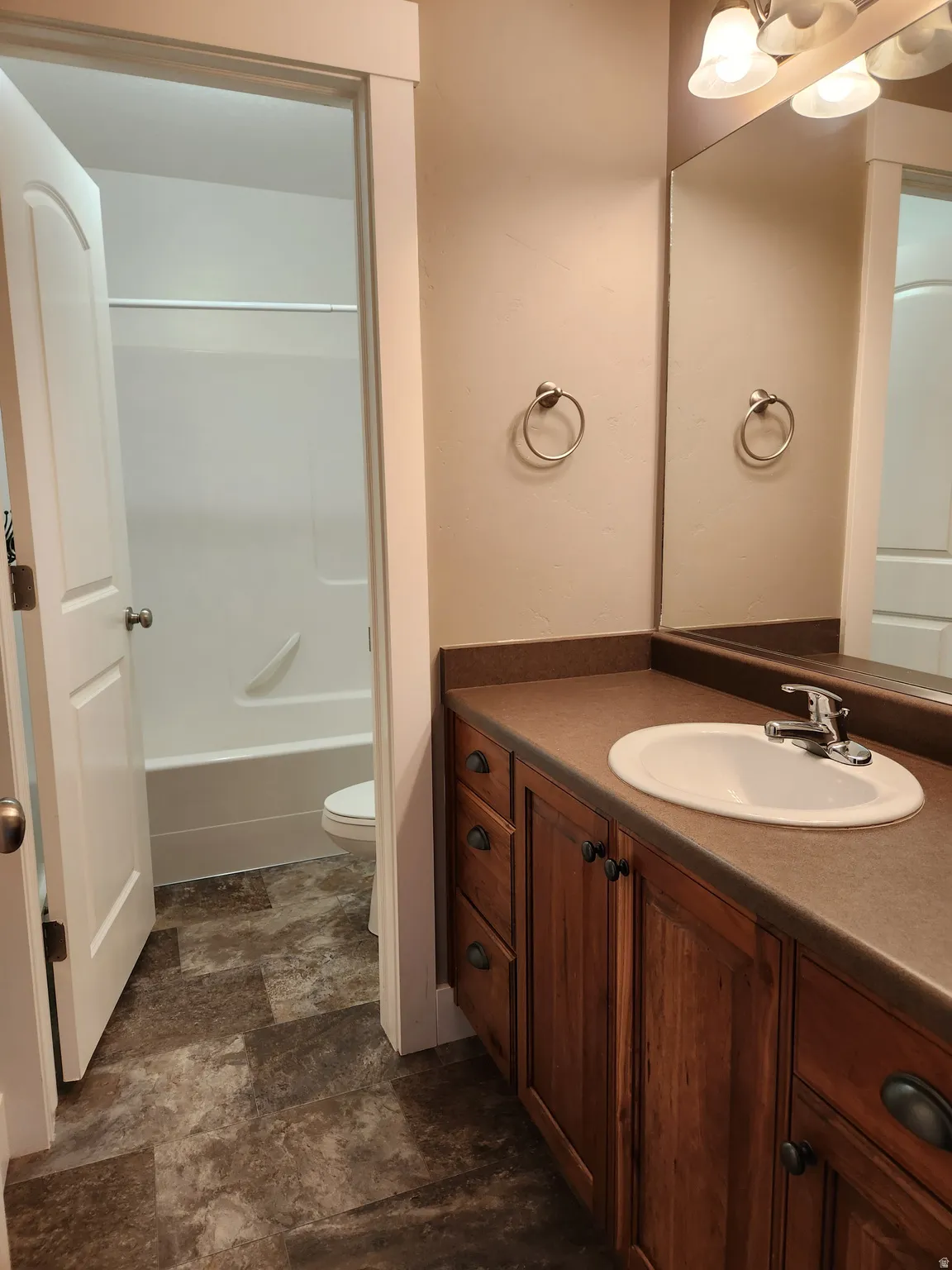Separated tub/shower in the upstairs bathroom with single vanity with drawers and cabinet storage