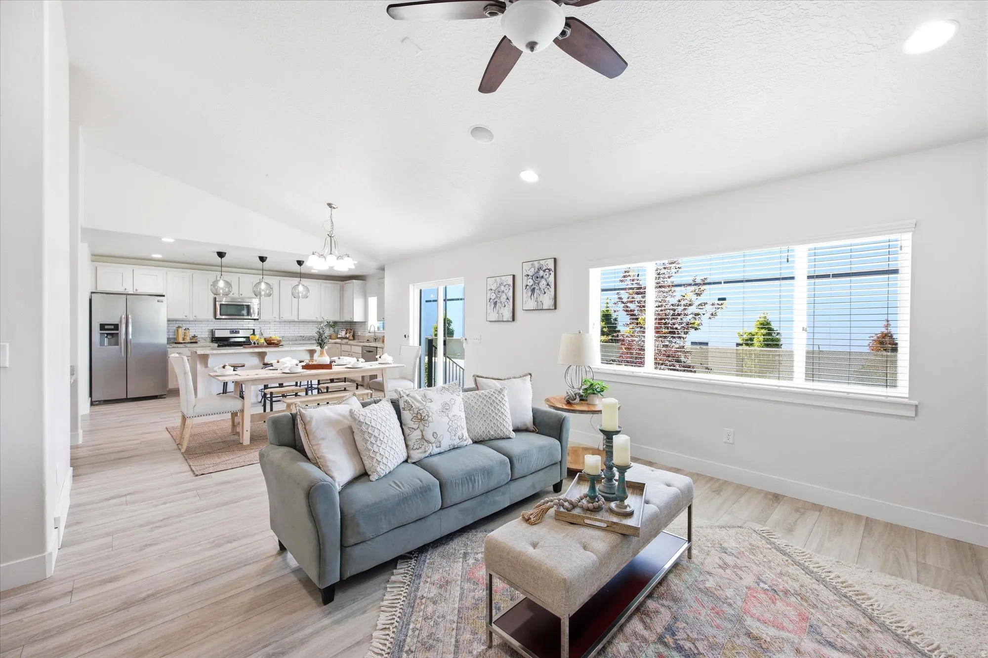 Open-concept living space featuring wood-finish flooring, recessed lighting, and a ceiling fan
