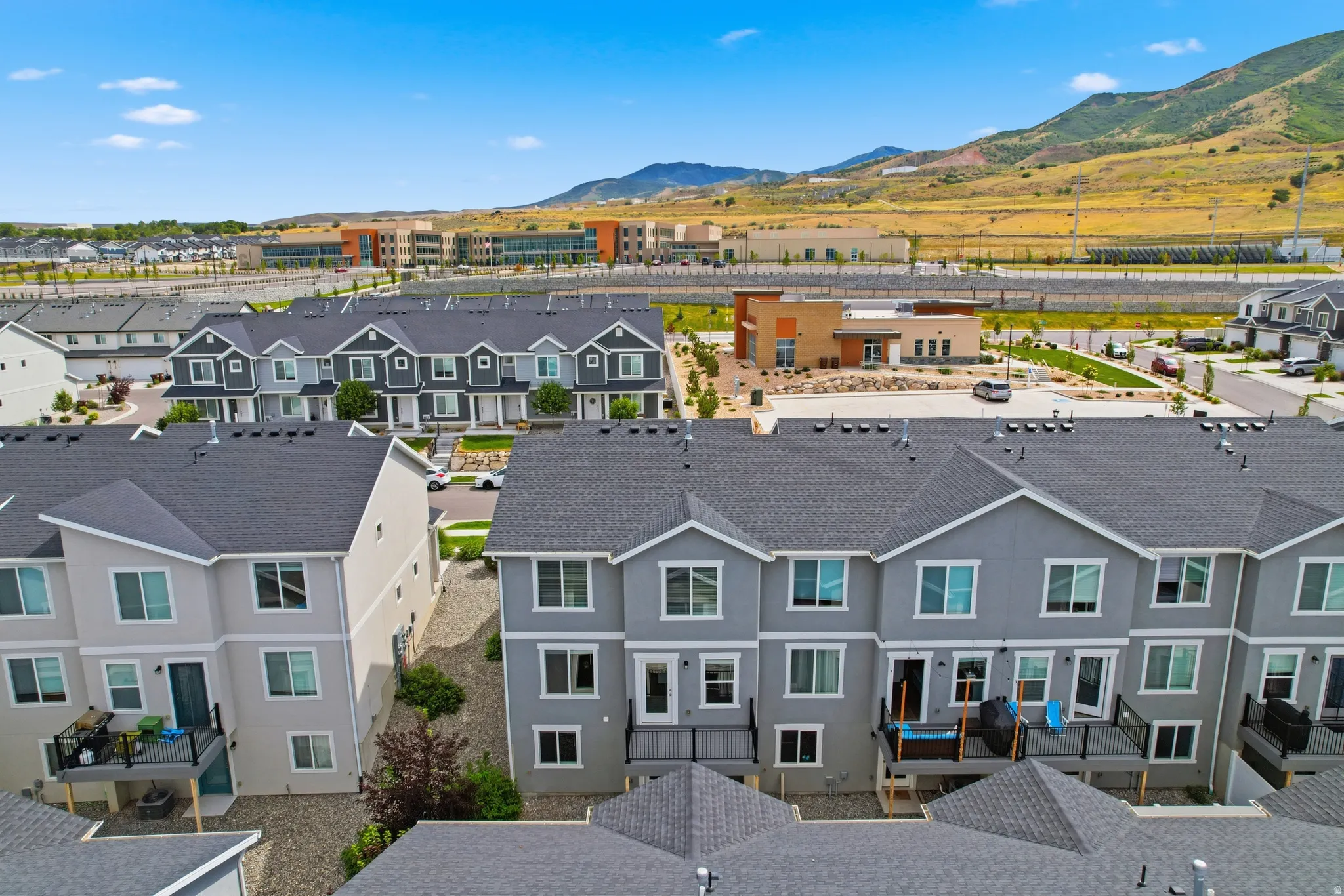 Contemporary townhome development featuring multiple units with private balconies and paved access