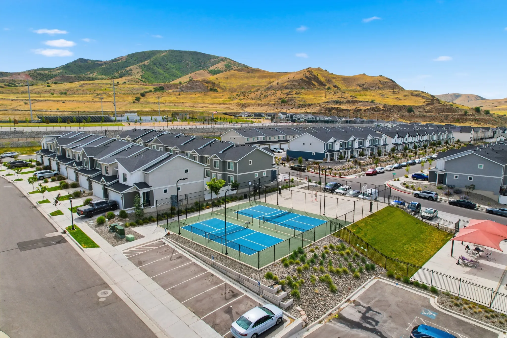 Contemporary townhomes featuring attached garages and landscaping