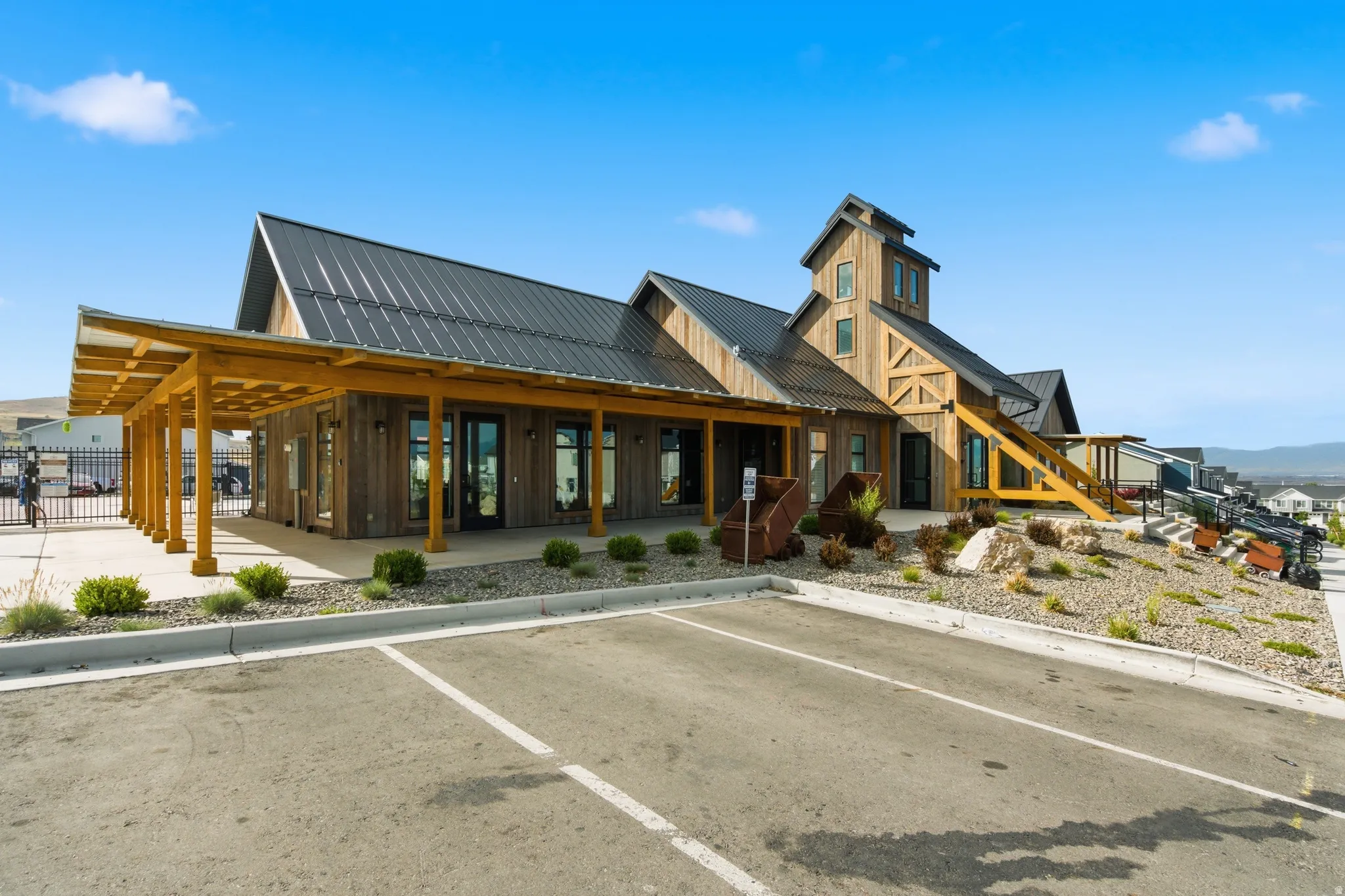 Wood-sided commercial building with a dark metal roof