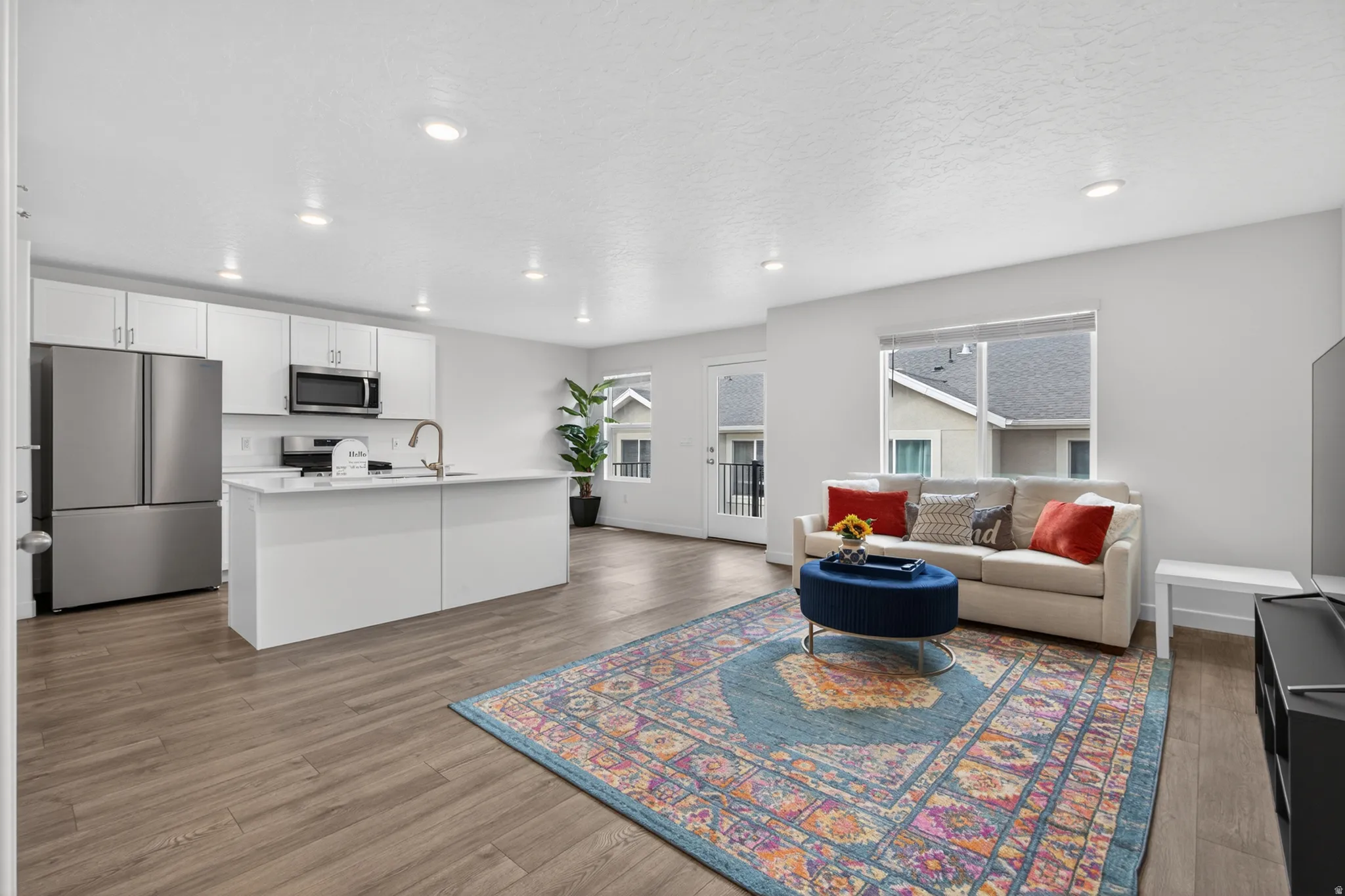Open-concept living space with wood-finish flooring