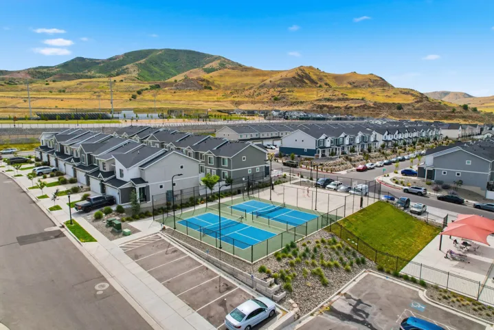 Contemporary townhomes featuring attached garages and landscaping