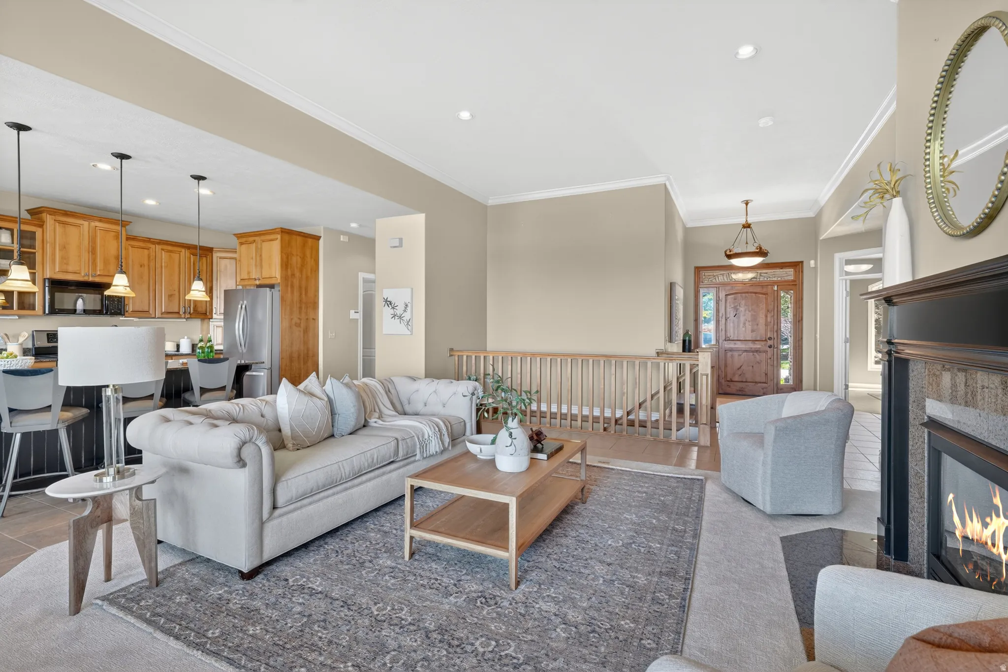 Spacious open-concept living area featuring 10 ft. high ceilings, crown molding, and recessed lighting