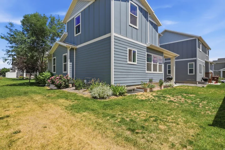 Exterior featuring horizontal siding, vertical siding accents, and white trim