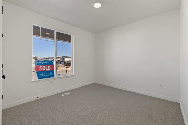 Bright interior room featuring a large double-pane window