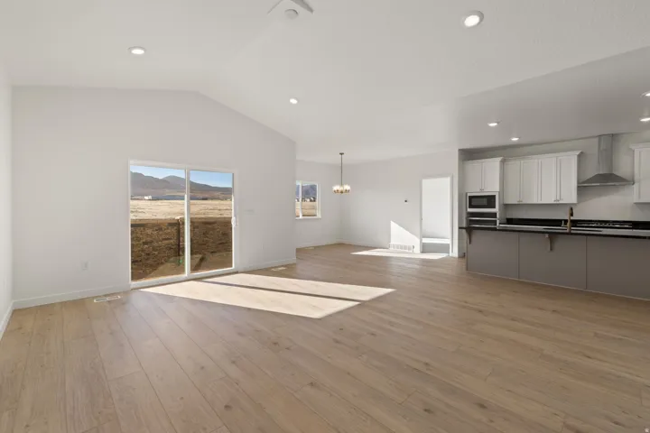 Open-concept living area featuring light wood-finish flooring and recessed lighting