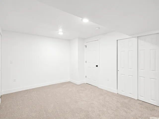 Neutral toned carpeting complements white walls