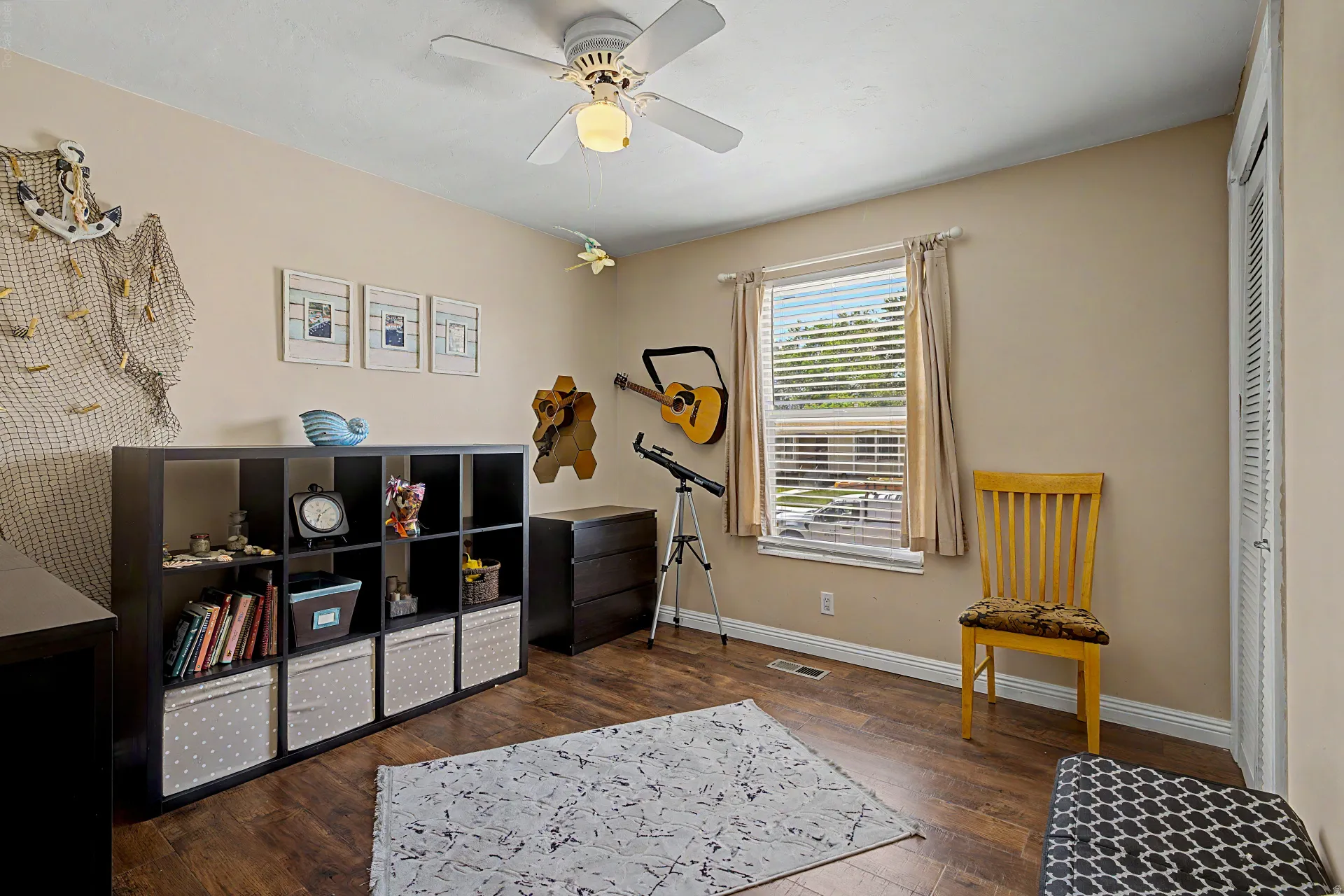 Spacious room featuring wood-finish flooring and neutral wall tones