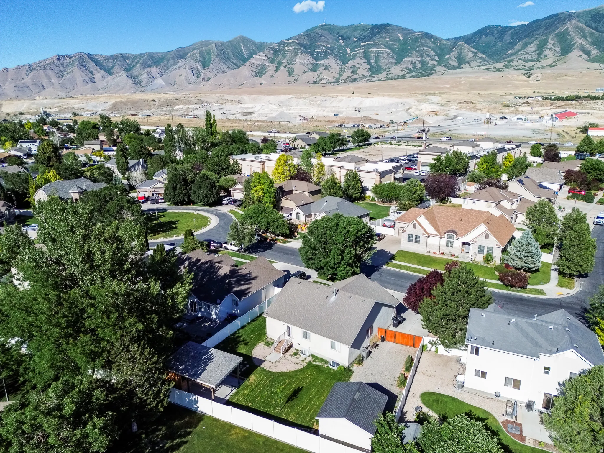 Aerial perspective showcasing a residential neighborhood with a mountain backdrop