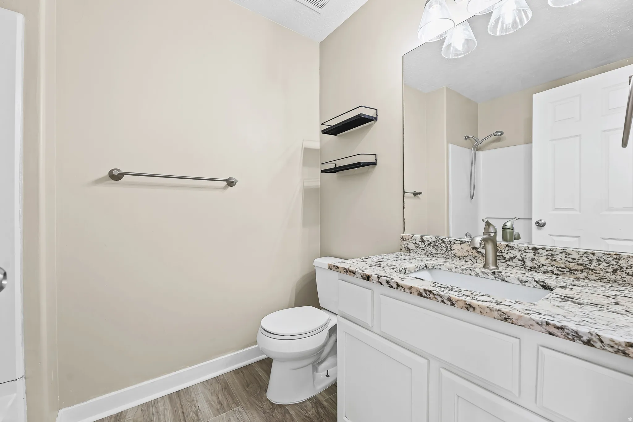 Bathroom featuring a vanity with a light-toned countertop, integrated sink, and brushed nickel faucet