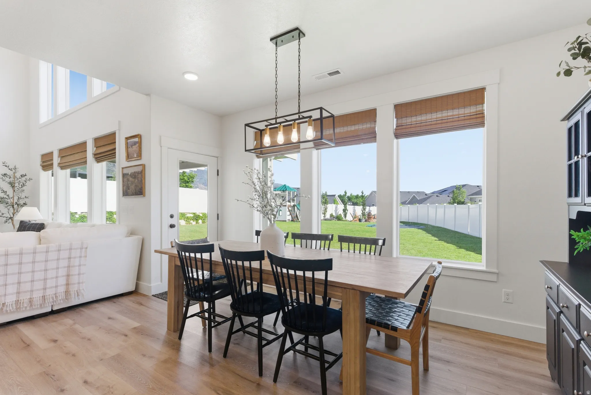 Dining area featuring wood-finish flooring and a rectangular light wood table