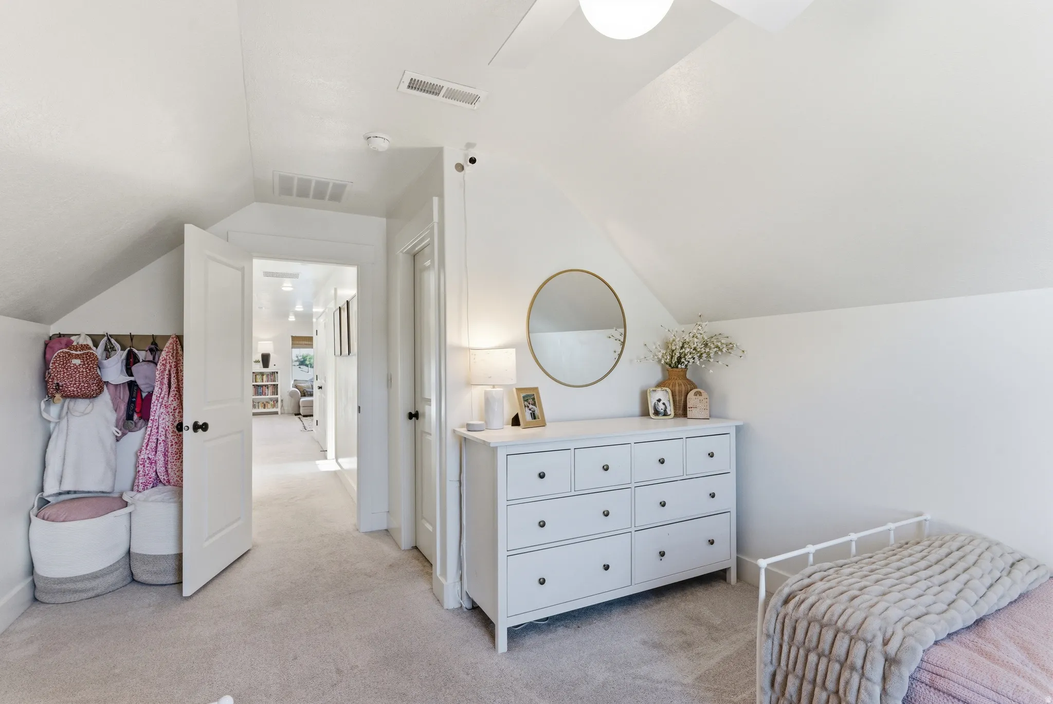 Carpeted room featuring a sloped ceiling and white walls