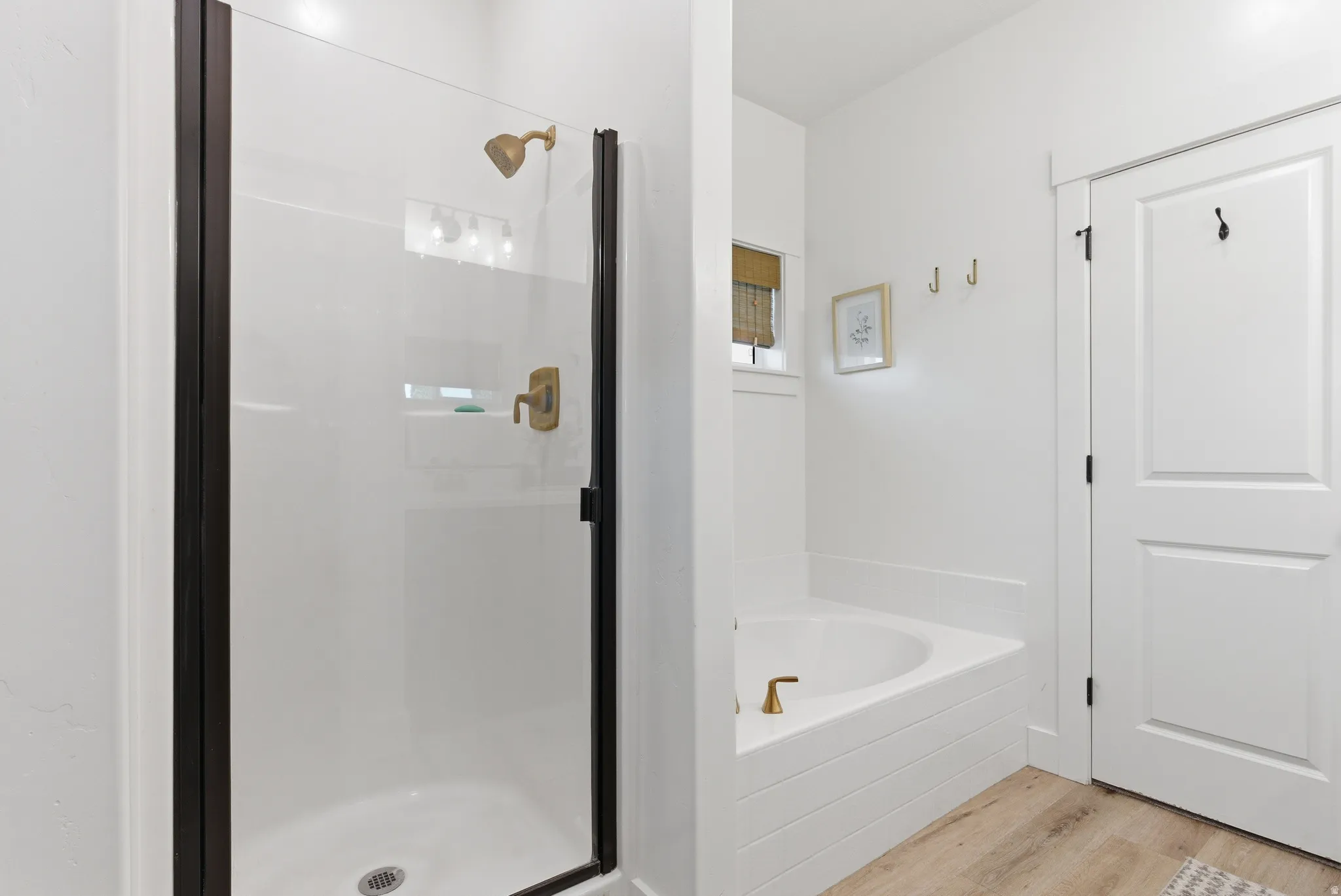 Walk-in shower with clear glass enclosure and bronze fixtures